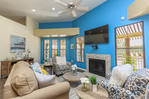 A living room with a fireplace and a television.