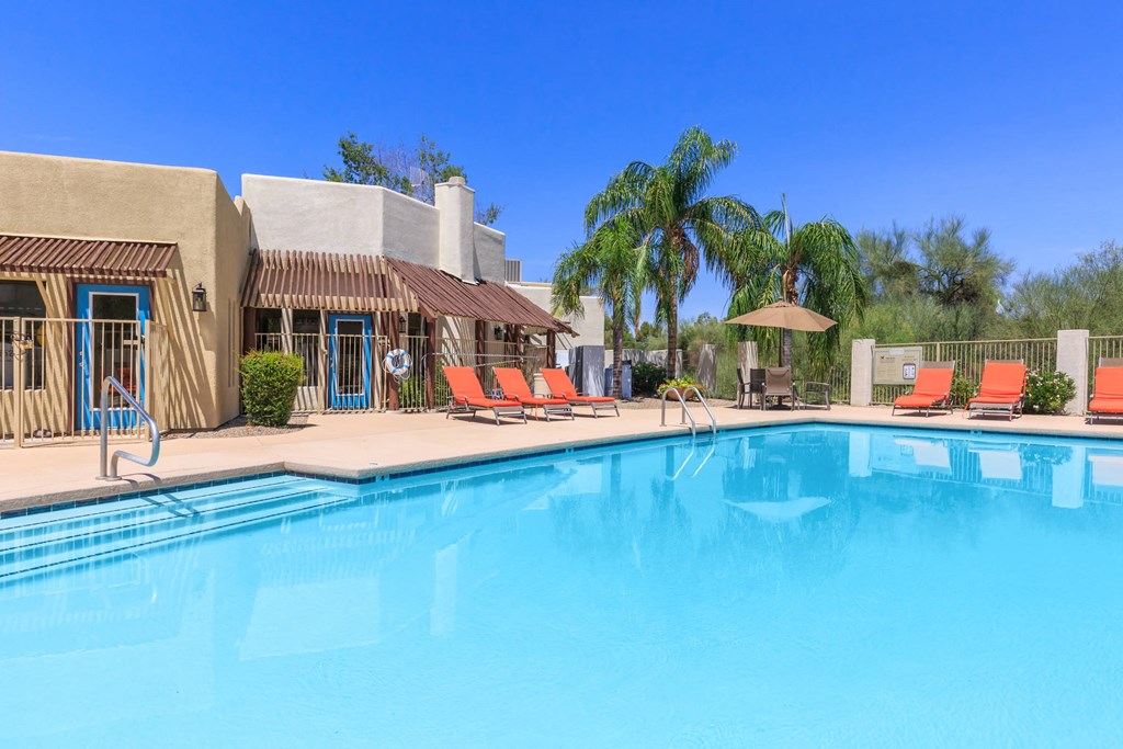 A pool with a building behind it.