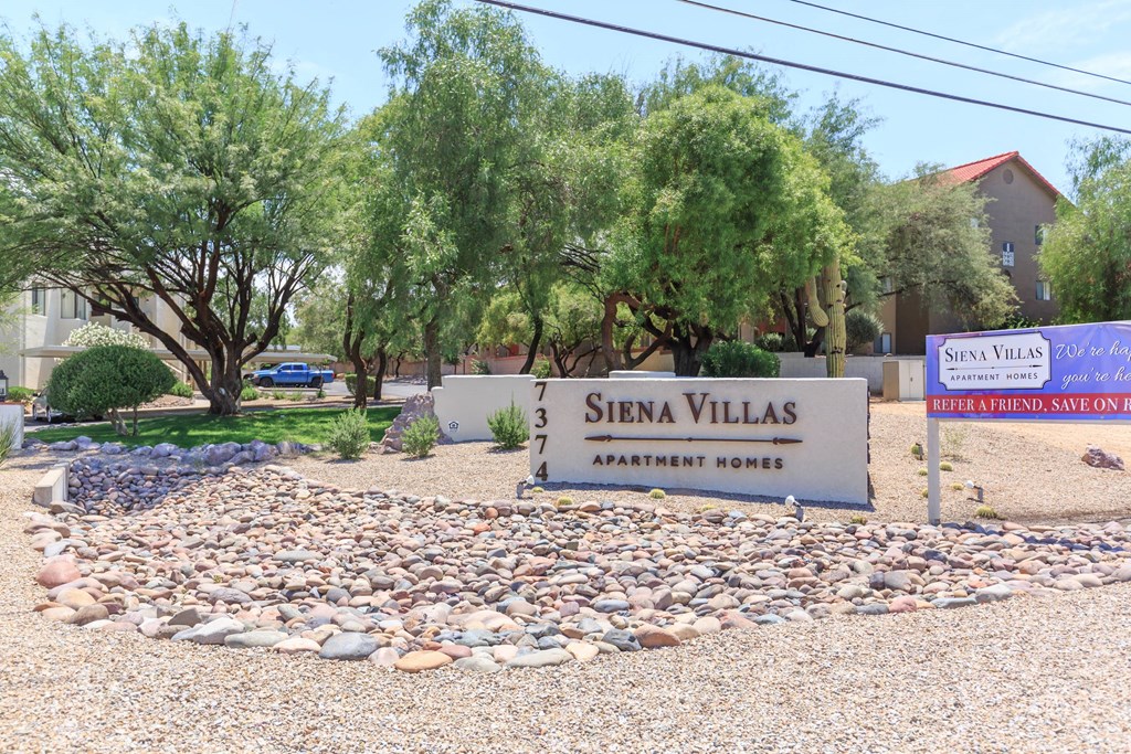 A sign for Siena Villas Apartment Homes is in front of a landscaped area.