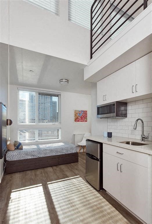 a kitchen with a sink a stove and a window