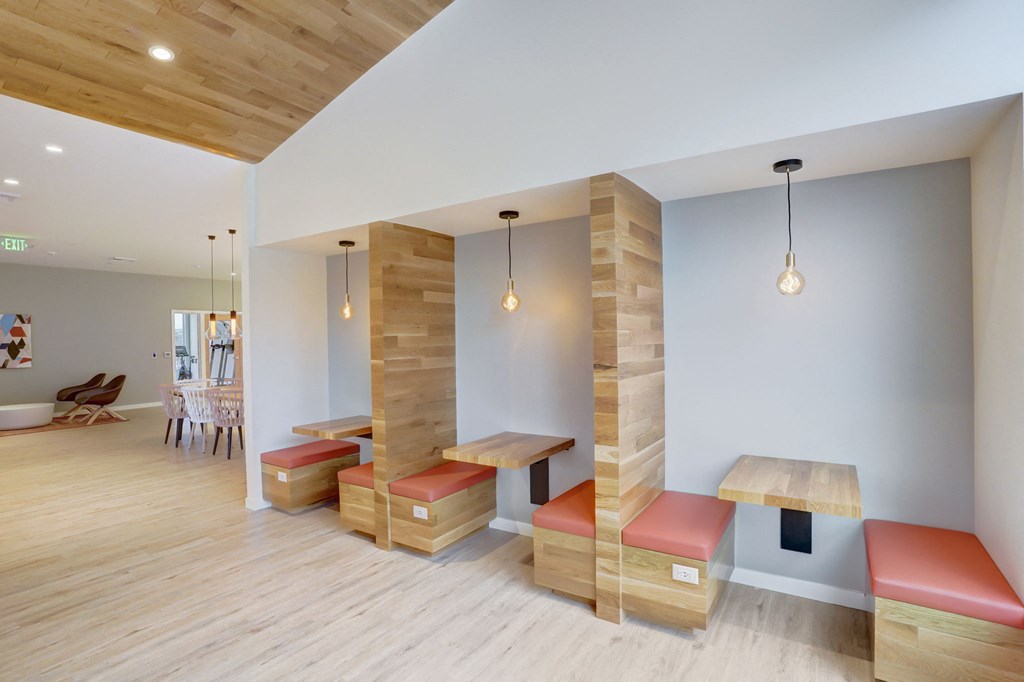 a seating area with benches and tables in a room