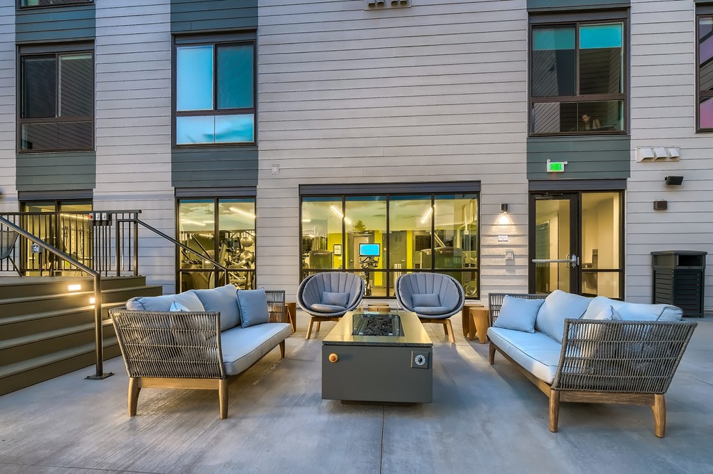 281 Willow Apartment  patio with couches and chairs and a fire pit