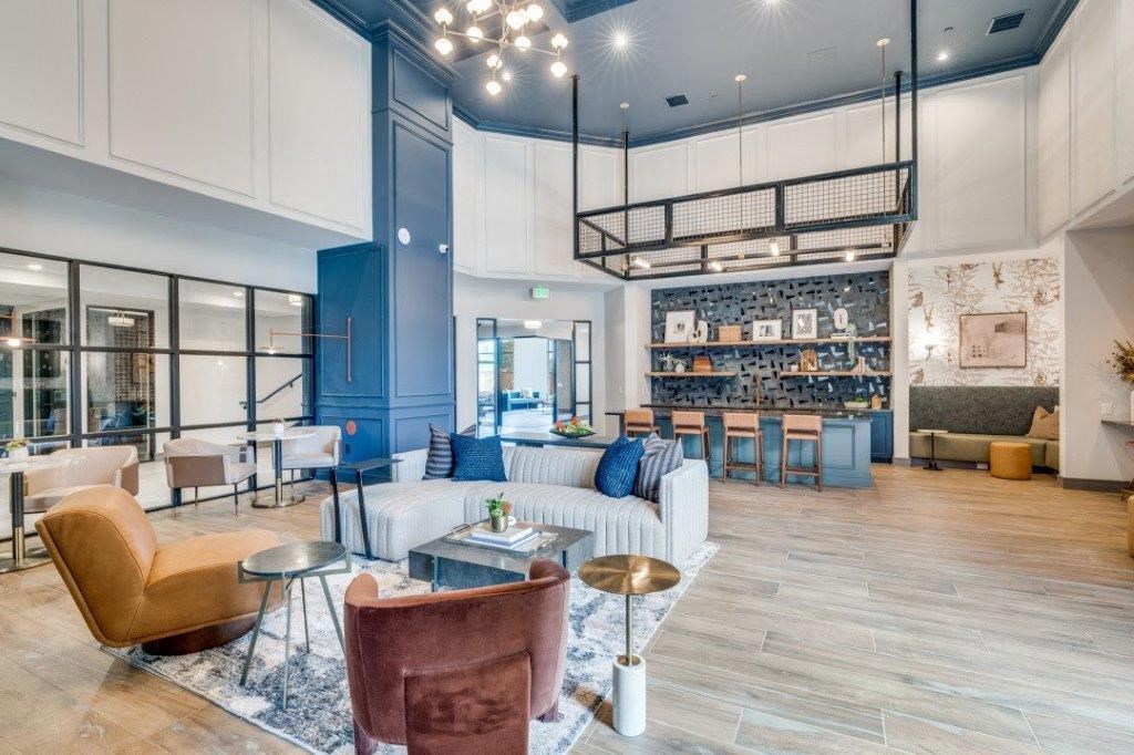 a living room filled with furniture and a large window