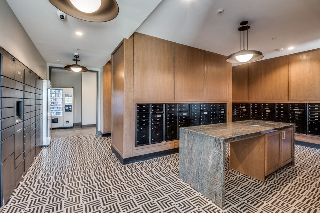 a large wine cellar with wooden cabinets and a granite counter top in a large room