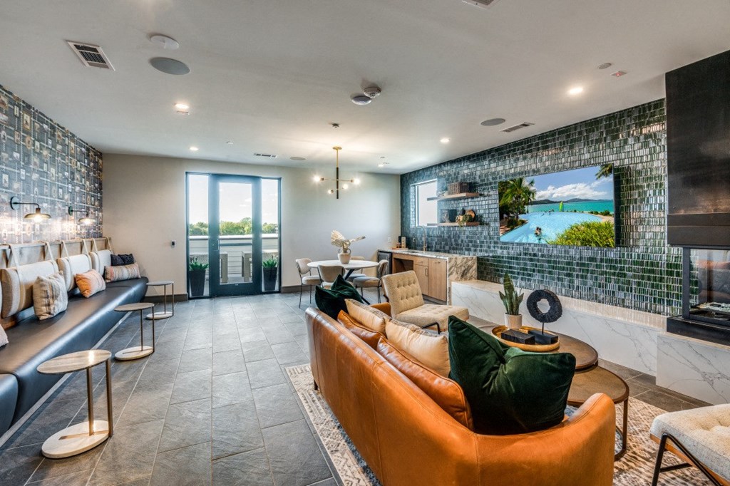 a living room with couches and a tv in front of a window
