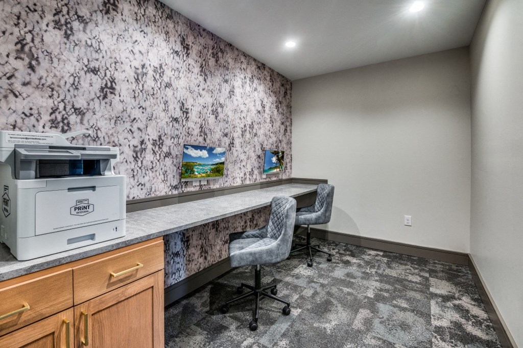 a home office with a printer and a desk with a chair