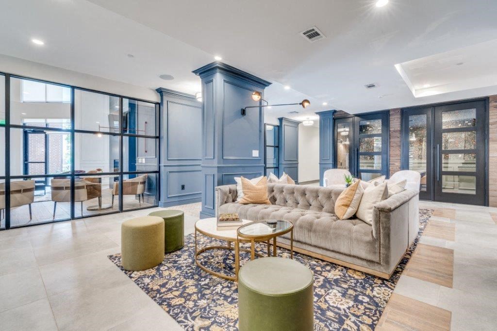 a living room filled with furniture and a large window