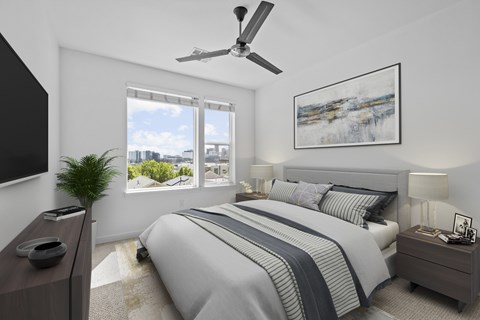 A bedroom with a large bed and a ceiling fan.