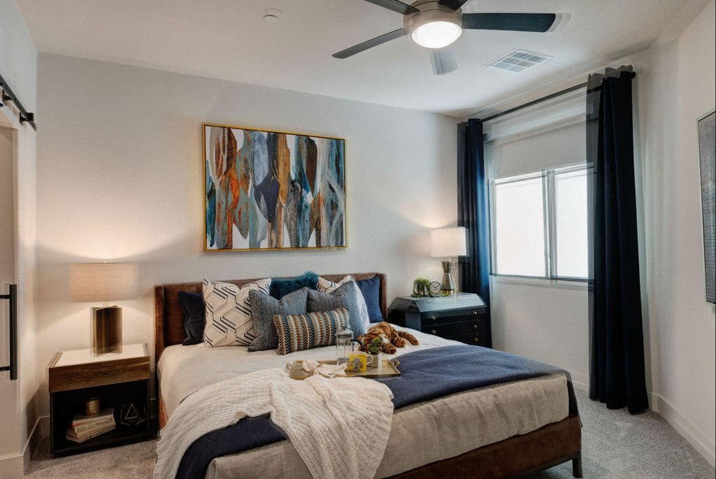 a bedroom with a bed and a ceiling fan