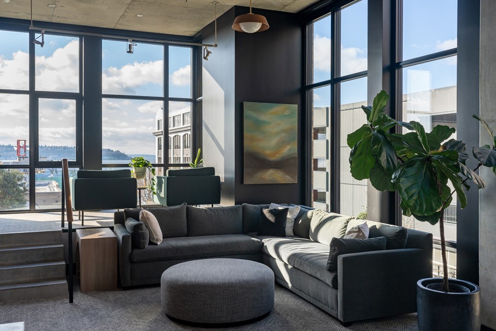 A living room with a large window overlooking the city.