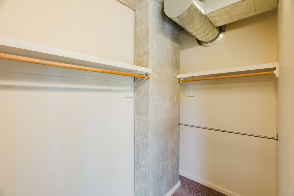 A white wall with a pipe running down it.