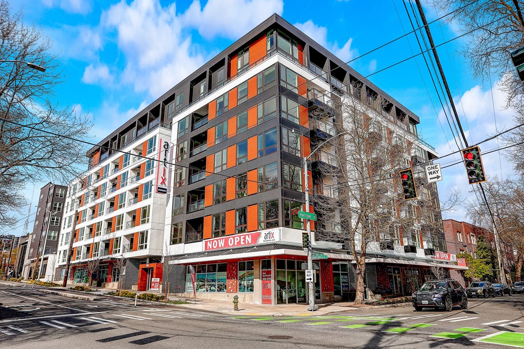 a large building with many windows and a sign that reads how open