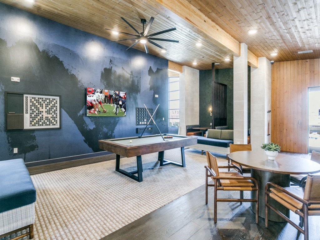 a game room with a ping pong table and a painting on the wall