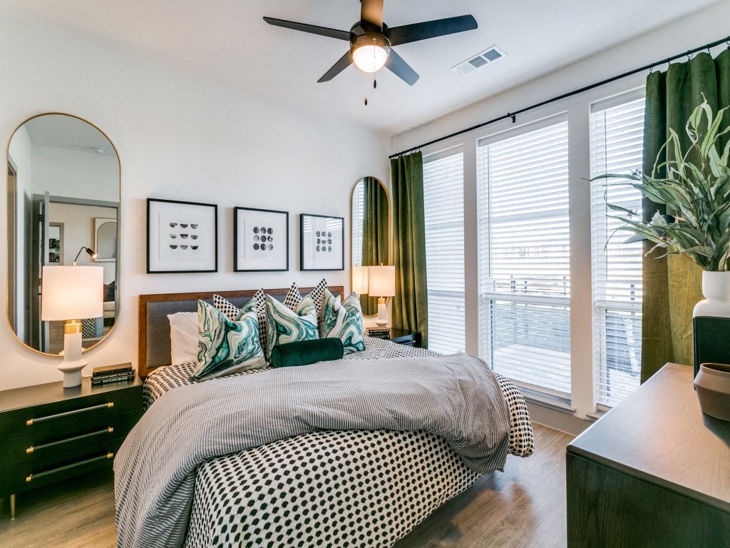 a bedroom with a large bed and a ceiling fan