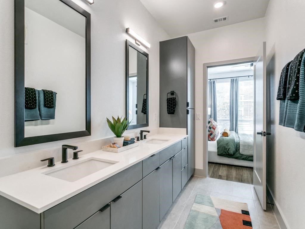 a bathroom with two sinks and a mirror