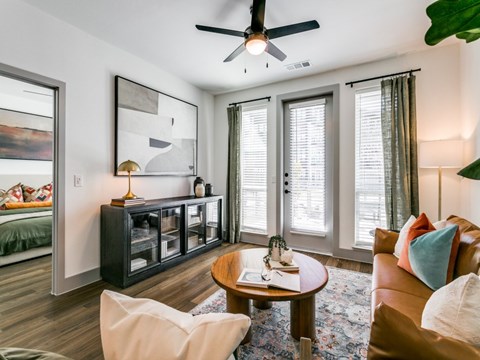 a living room with a couch and a ceiling fan