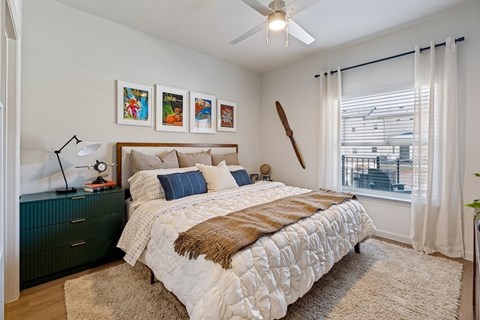 A bedroom with a large bed and a green cabinet.