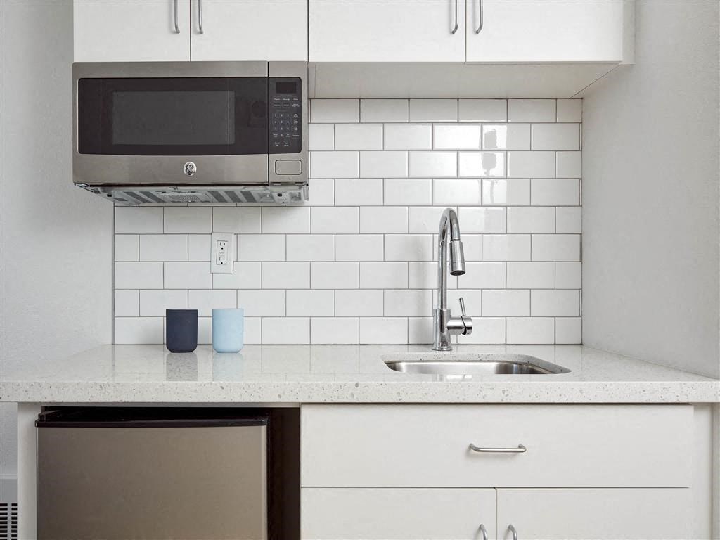 a kitchen with a sink and a microwave