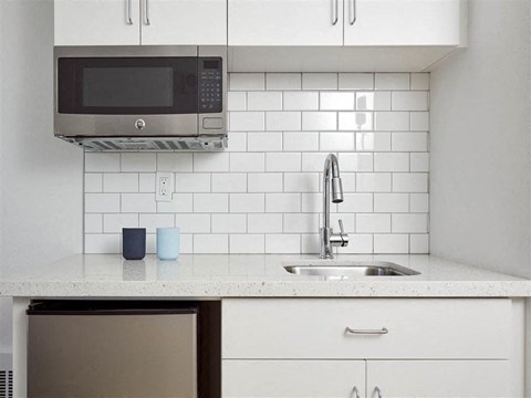 a kitchen with a sink and a microwave
