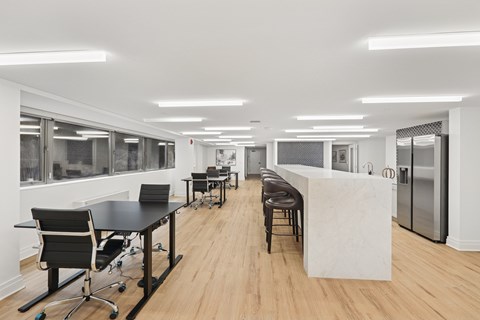 A conference room with a long table and chairs.