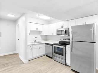 Proximity Apartment Homes Kitchen with stainless steel appliances and white cabinets