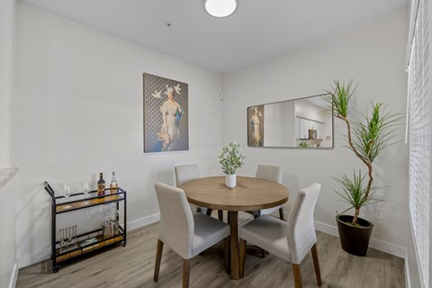 A dining room with a round table and chairs.