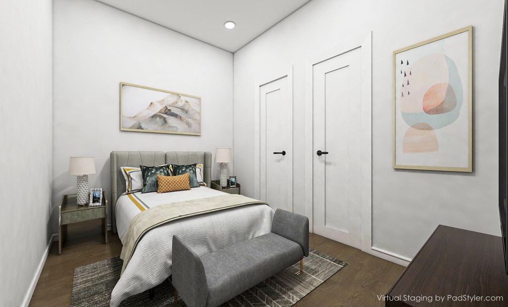 A bedroom with a bed, two nightstands, a bench, and two framed pictures on the wall.