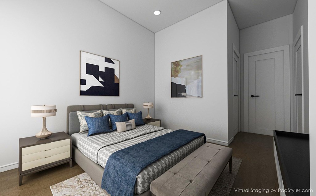 A bedroom with a bed, nightstand, and two lamps.