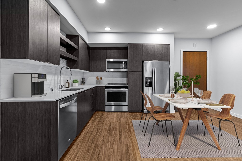 a kitchen and dining room with a table and chairs