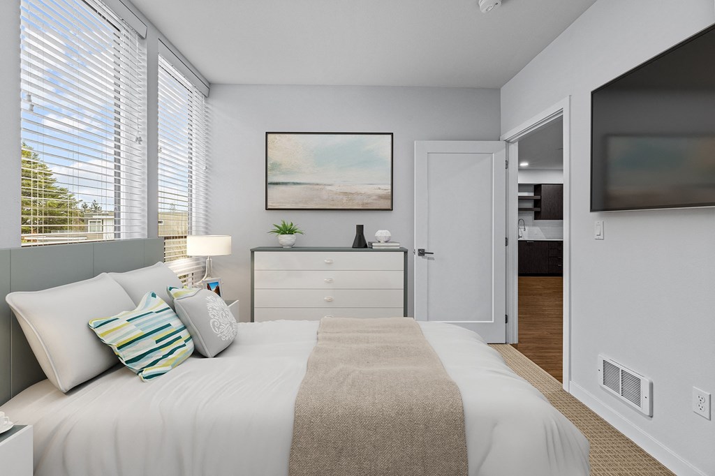 a bedroom with a large bed and a window