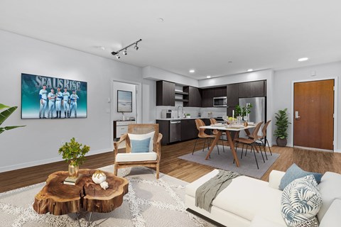 A modern living room with a wooden coffee table and a painting of a group of people.