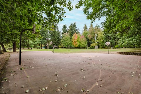Nearby Laurelhurst Park with basketball court surrounded by trees by 2121 Belmont apartments in the Buckman neighborhood in Portland, Oregon.