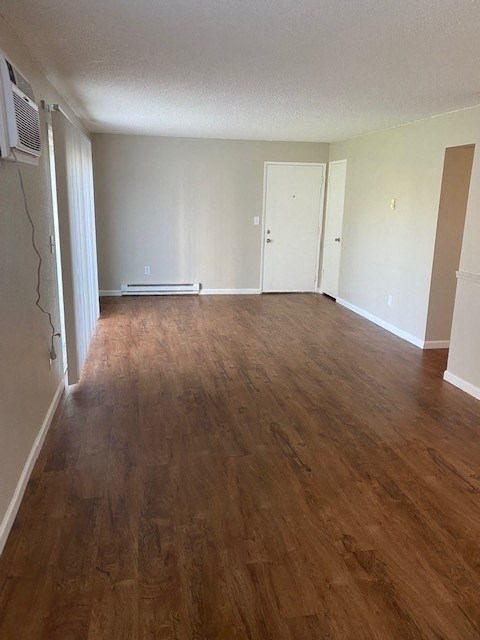 an empty living room with a hardwood floor