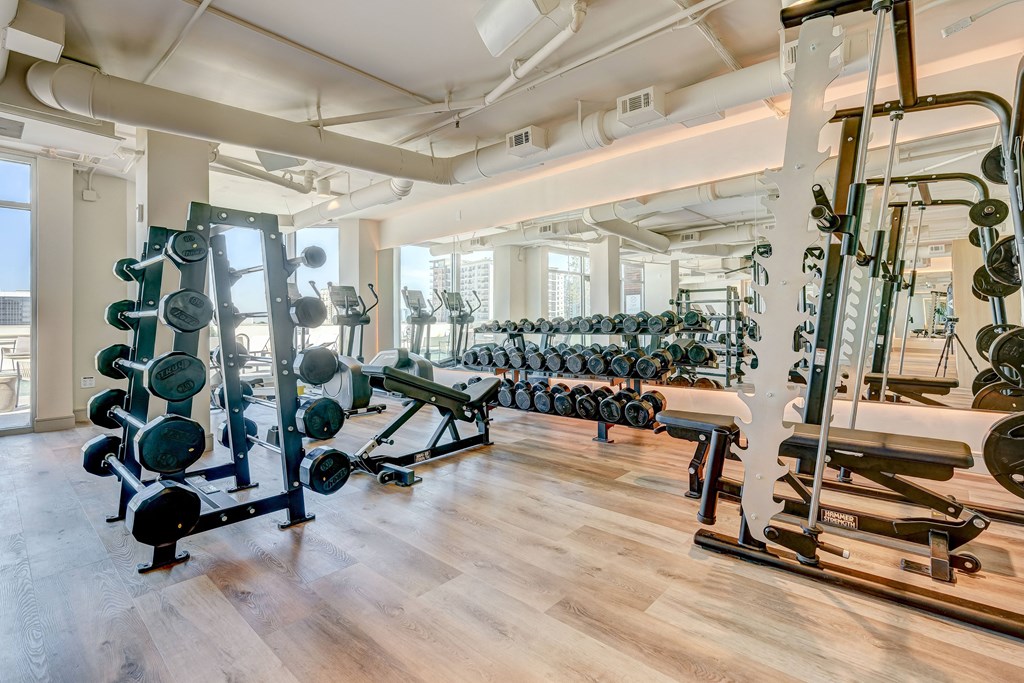 a fitness room with weights and other exercise equipment