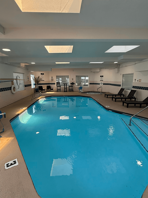 A large indoor swimming pool with lane markers and a starting block.