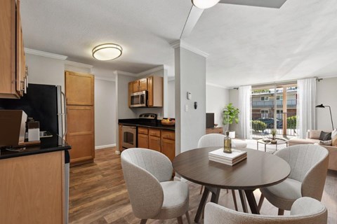 A modern kitchen with a dining table and chairs.