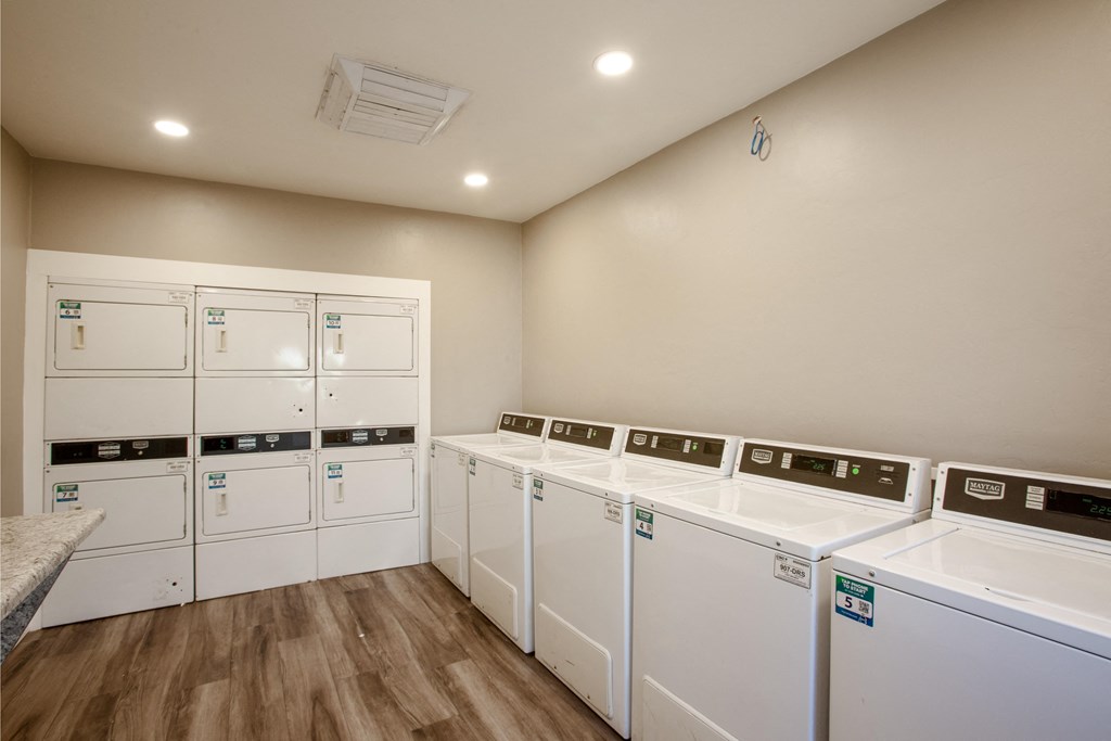 A row of washing machines in a laundry room.