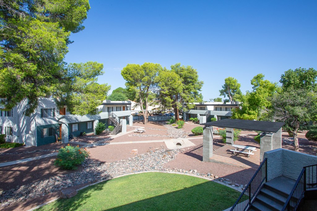 A backyard with a patio and a small garden.