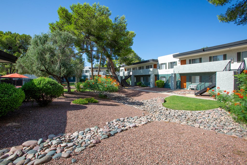 A residential area with a gravel path and a stone wall.