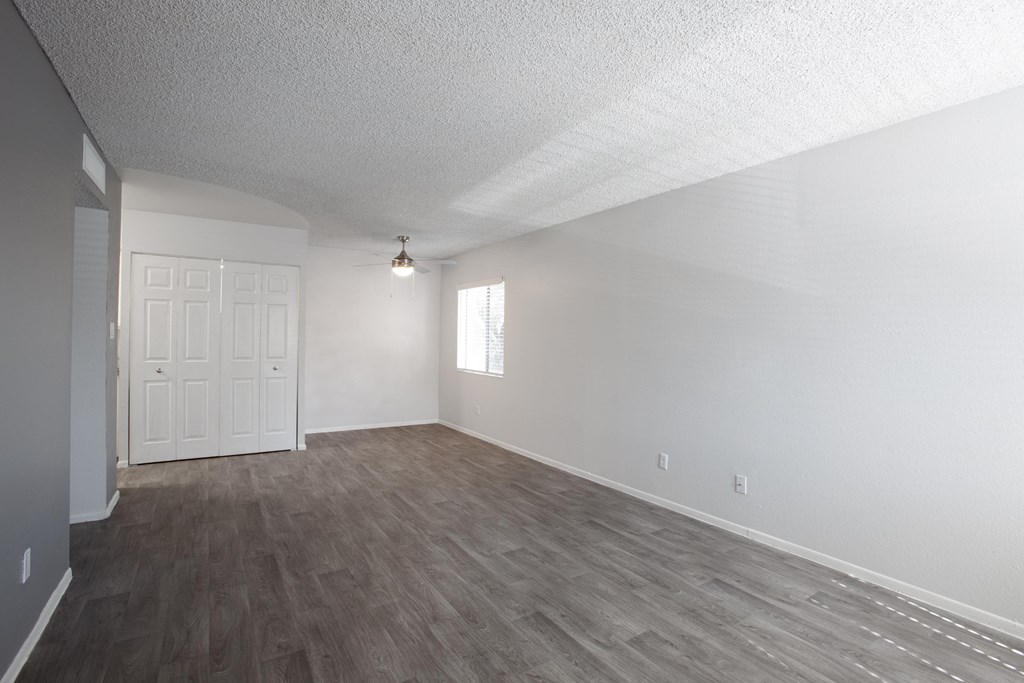 A room with a white door and a window.