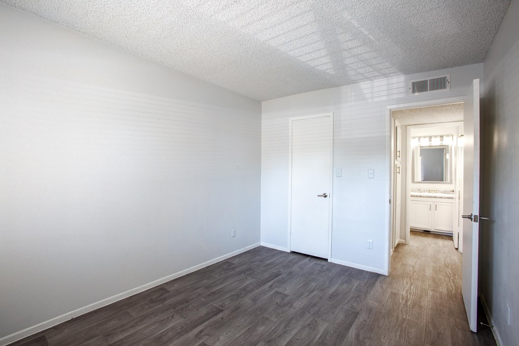 A room with a white door and a window.