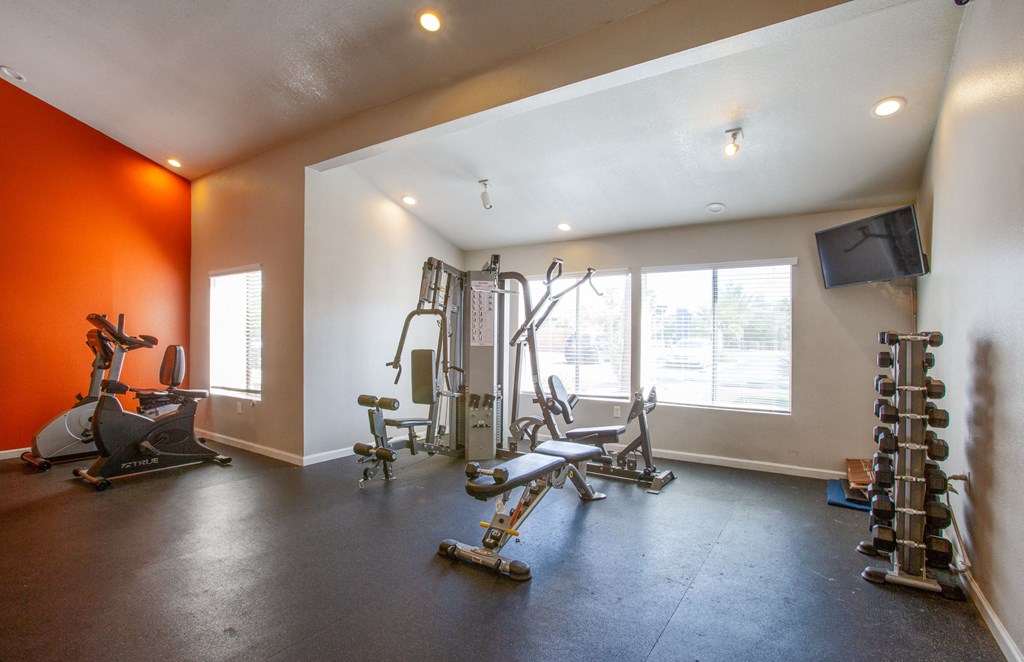 A spacious home gym with a variety of exercise equipment.