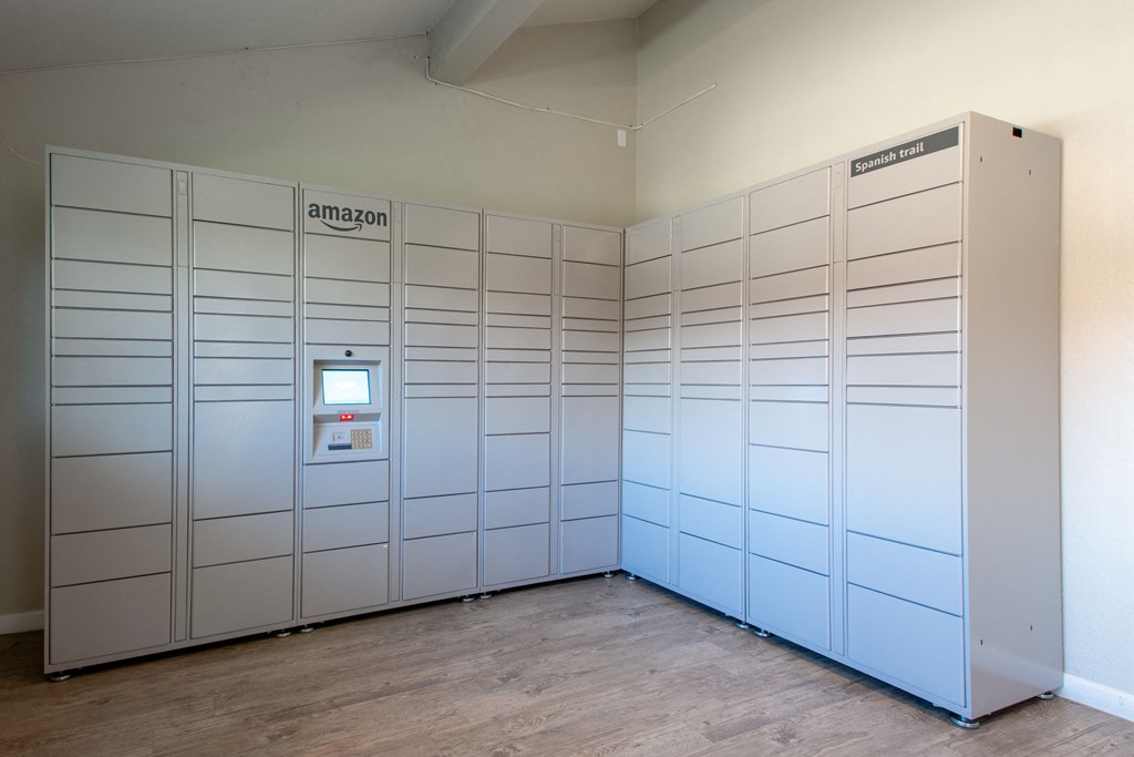 A row of Amazon lockers are lined up in a room.