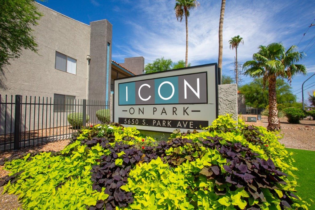 A sign for Icon on Park stands in front of a building.