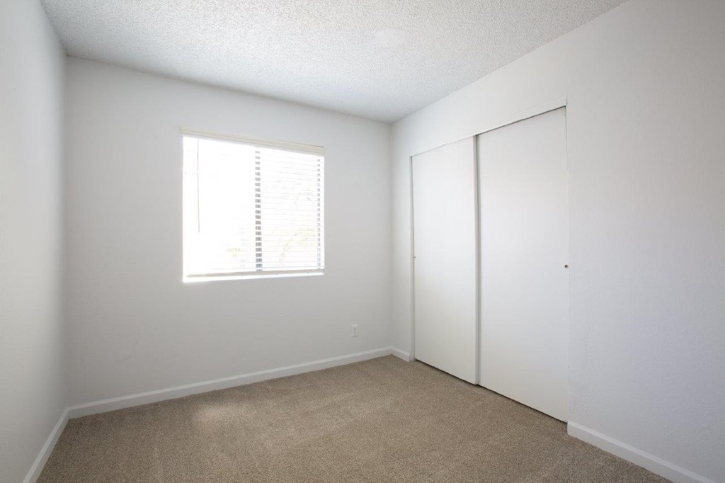 A room with a window and a door.