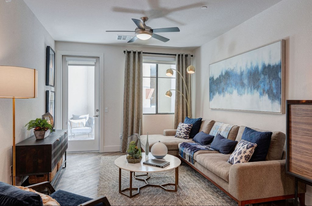 a living room with a couch and a ceiling fan
