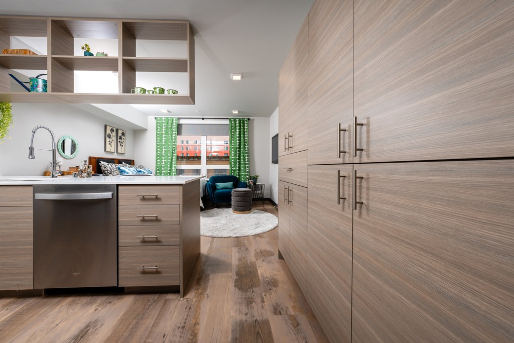 A modern kitchen with wooden cabinets and a stainless steel dishwasher.