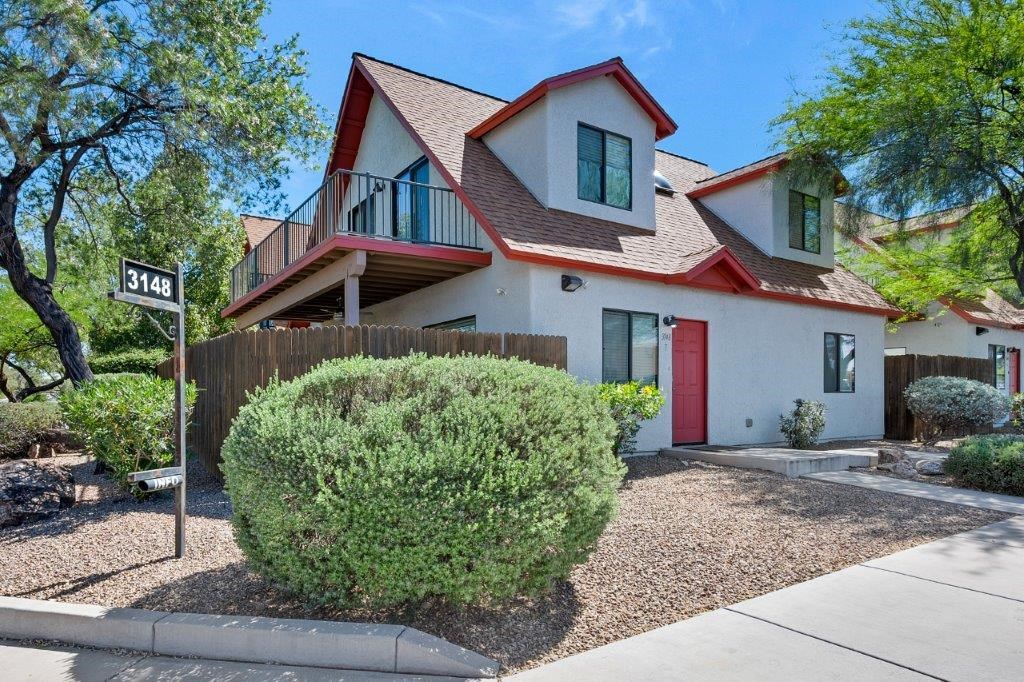 A house with a red door and a sign that says 3148.