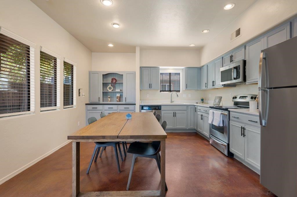 A kitchen with a table and chairs in the middle of the room.