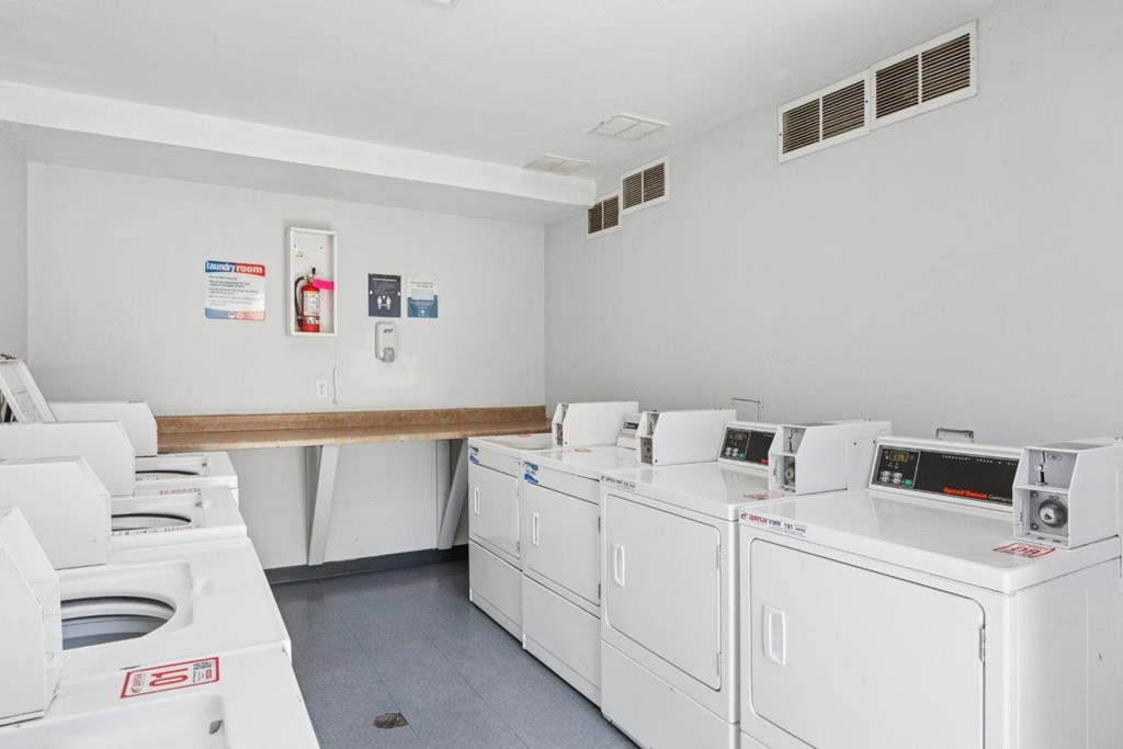 A row of washing machines in the laundry room